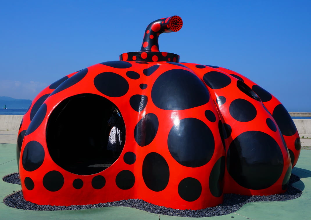 a modern artwork, red pumpkin shape playhouse