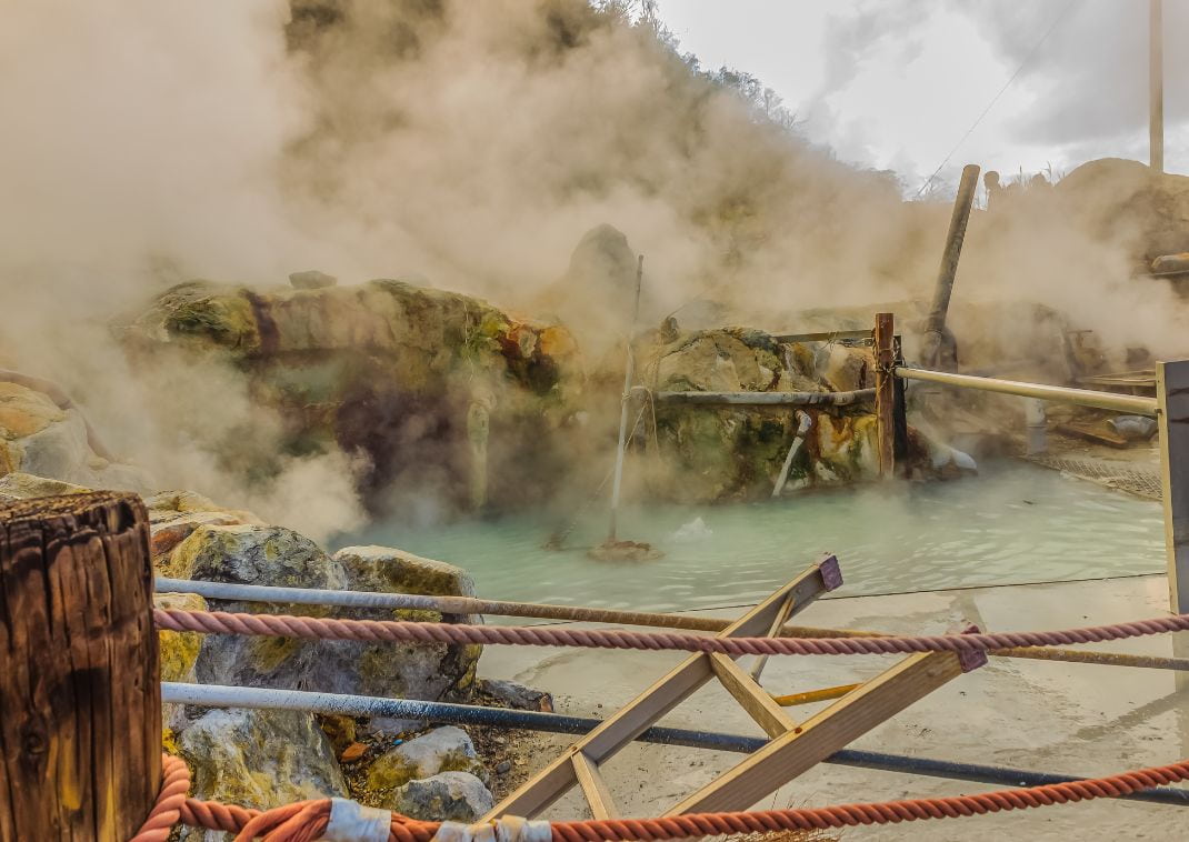 Owakudani hot spring pond with misty and active sulfur vents