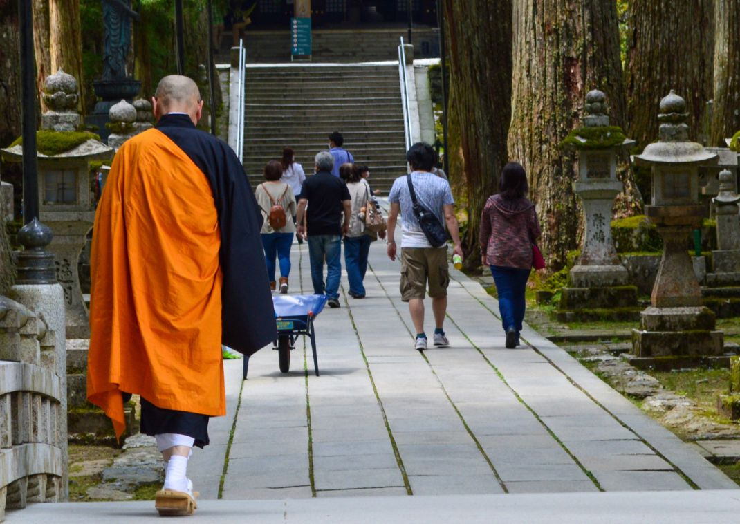 A monk making his way to the temple from the bridge