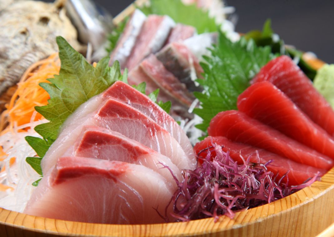 Fresh Japanese sashimi in a wooden serving bowl