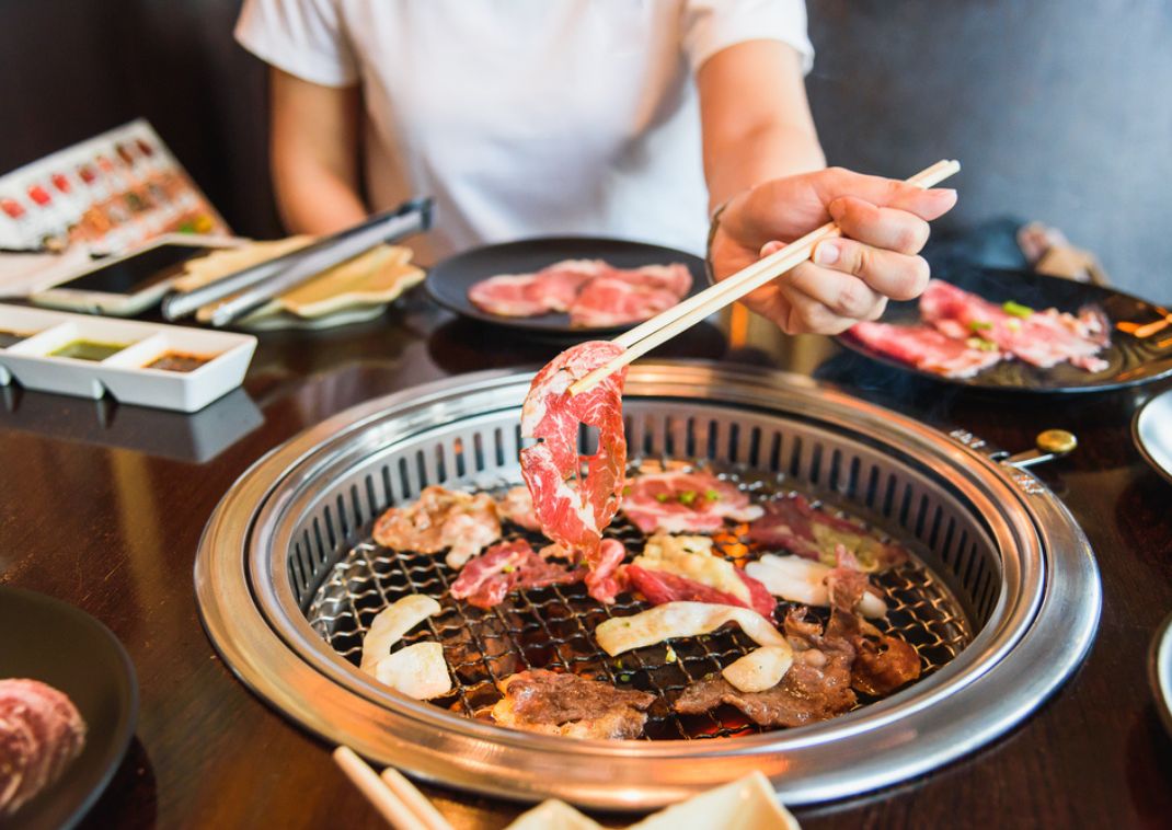 Cooking meat on a grill in a yakiniku restaurant