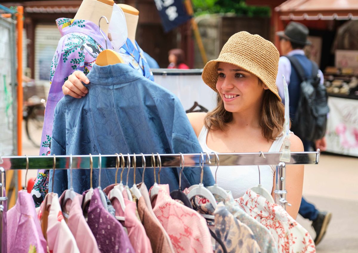 Tourist girl choosing kimono at a Japanese shop