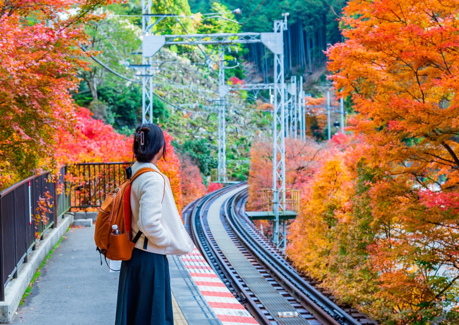 Girl waiting for train in Japan in autumn