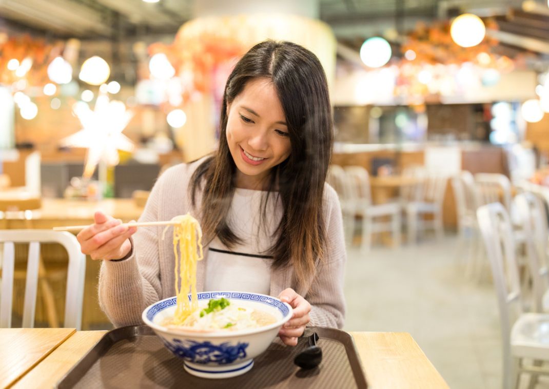 Lady enjoying ramen, Japan