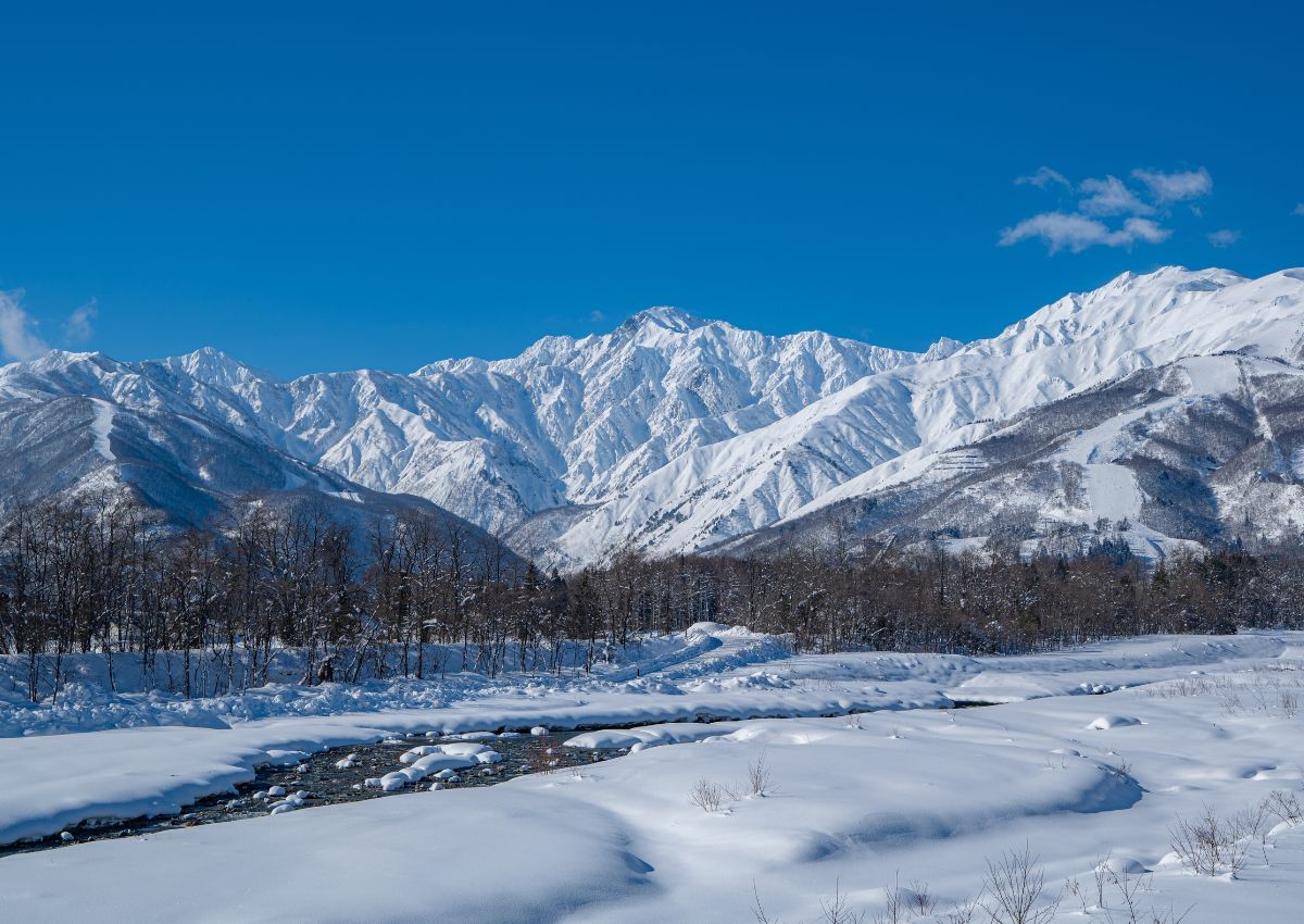 Clear skies with snowy mountains in Hakuba, Japan