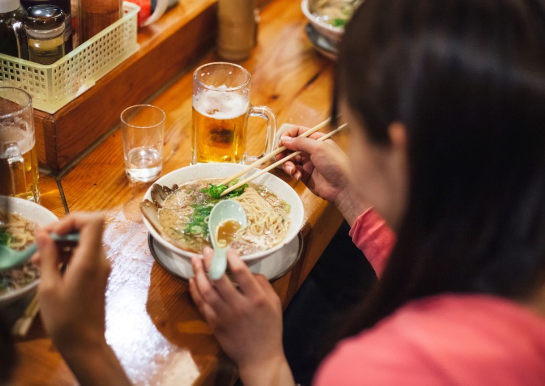 Two friends eating ramen, Japan