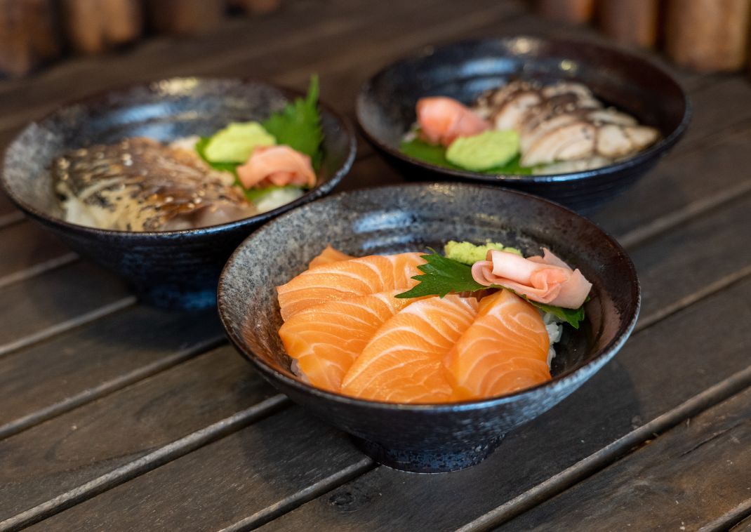 Three bowls of Japanese sashimi served traditionally 