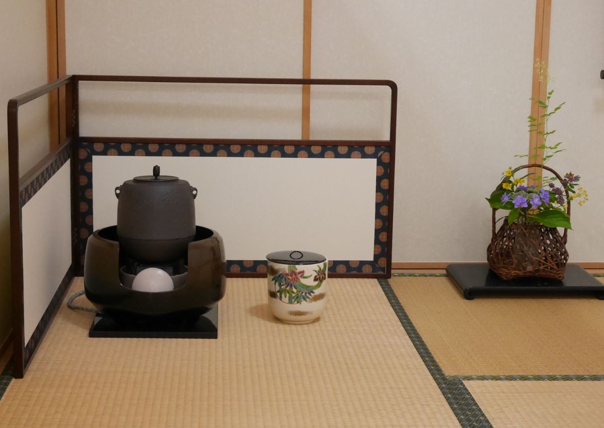 Tea room setup with ikebana flower arrangement