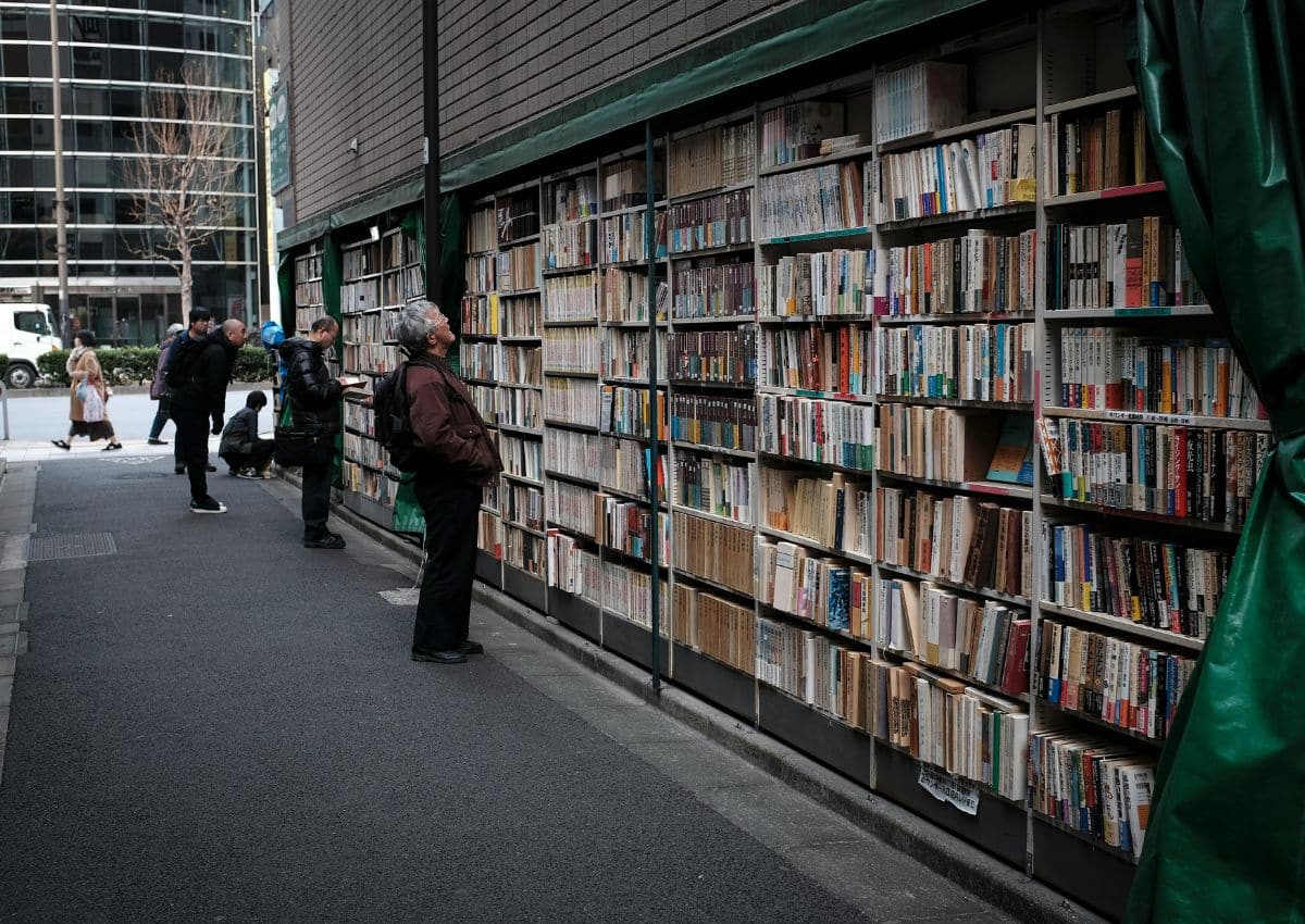 Elderly man looking at second-hand books in Tokyo