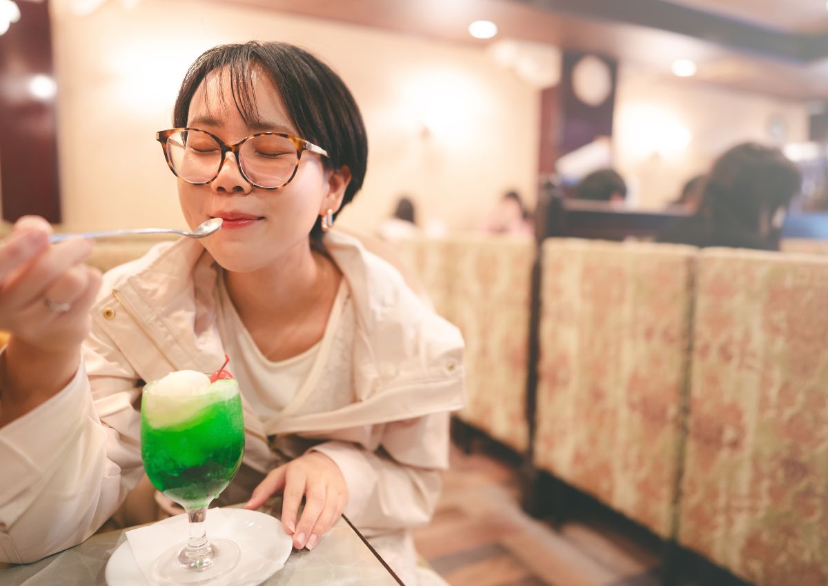 Girl enjoying cream soda in Japanese kissaten