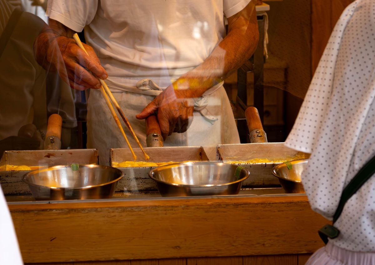 Cooking tamagoyaki omelettes at street market, Tokyo