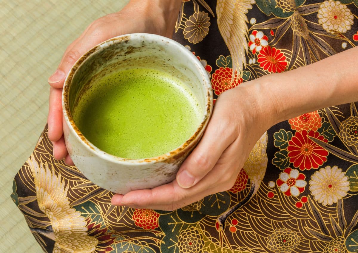 Hands holding a bowl of fresh matcha