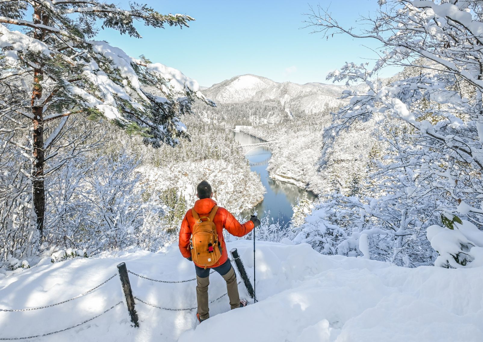 Man hiking in winter along the Tadami Railway Line, Fukushima, Japan