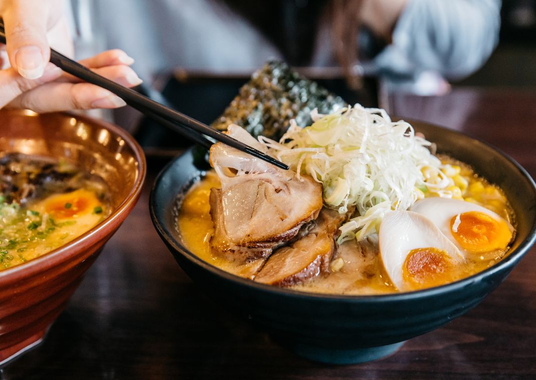 Woman eating Pork Ramen noodles, Japan