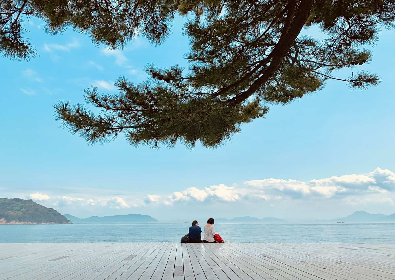 People sitting on Naoshima's sunny seaside