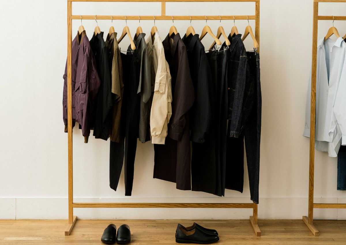 Japanese clothing and shoes displayed on a wooden rail.