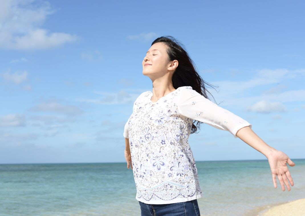 Relaxed woman by the sea, Okinawa