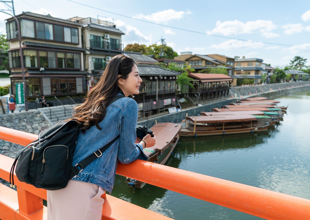 Tourist girl on bridge in Uji, Kyoto, Japan