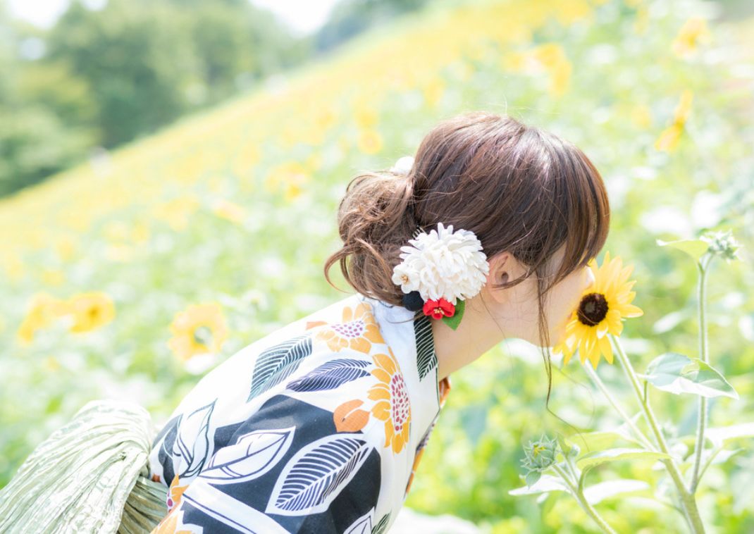 Girl in yukata dress in sunflower festival, Japan
