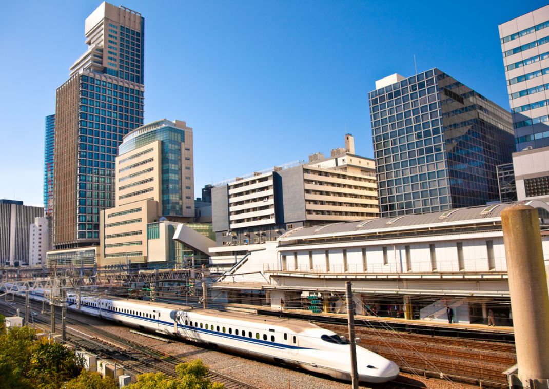 City of Hakata in Fukuoka, Japan at twilight with a blue hue and twinkling city lights