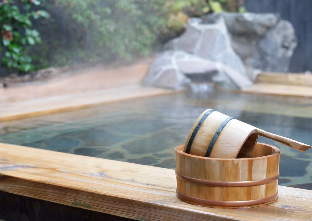 Traditional wooden bathing tools in front of bath in Japan