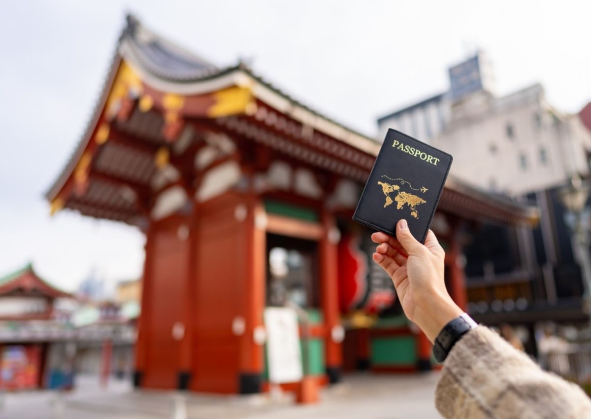 Woman’s hand holding up a passport in Tokyo