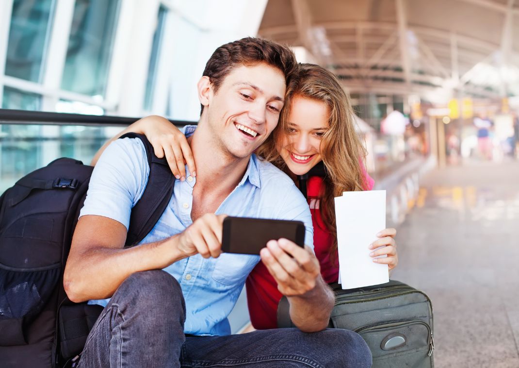  Couple taking selfies in airport