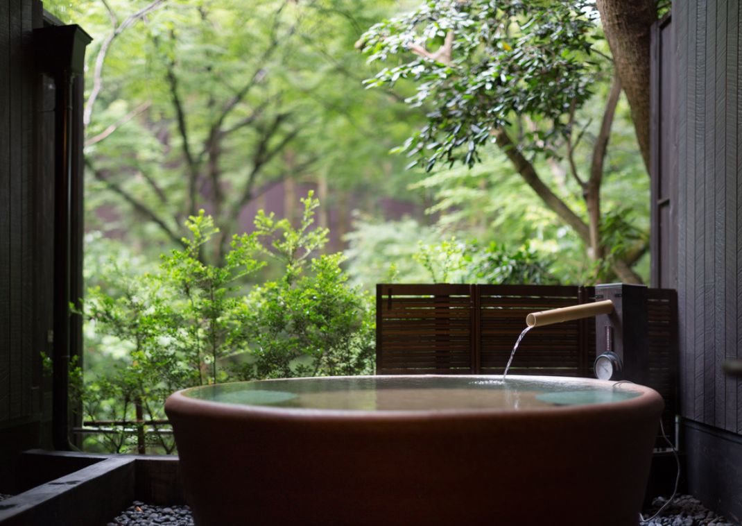 Outdoor onsen and garden at a traditional Japanese ryokan