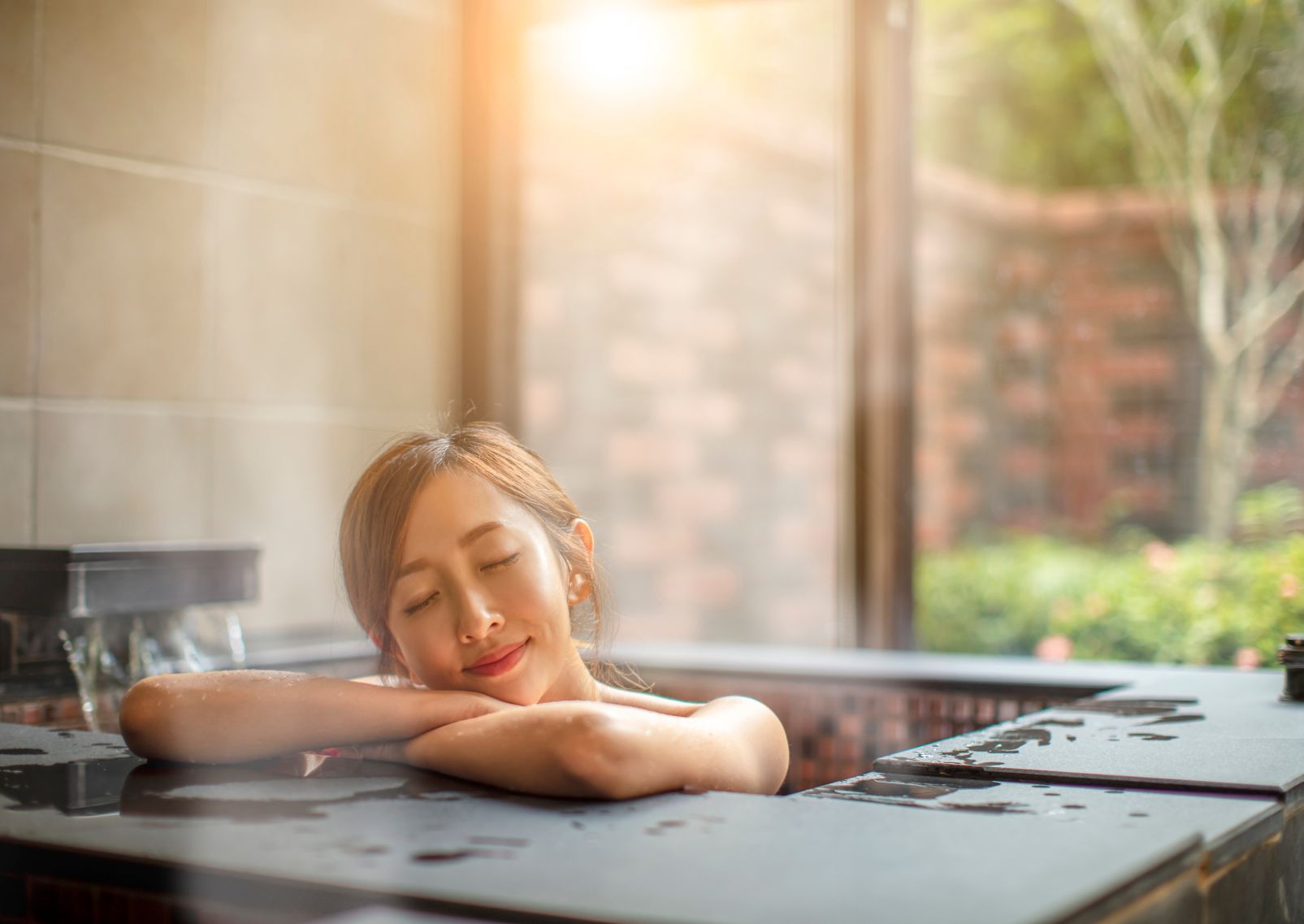 Woman relaxing in hot spring, Japan