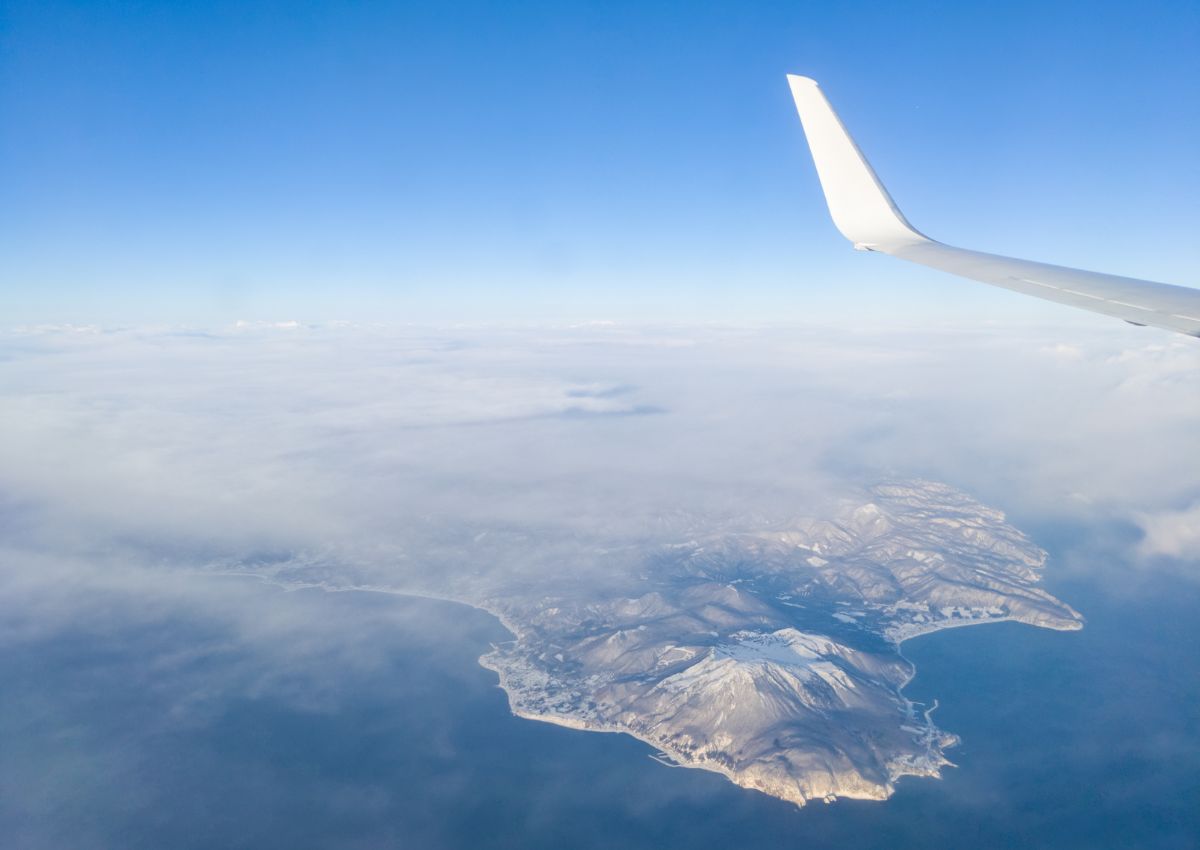 Airplane flying over winter landscape of Hakodate, Hokkaido