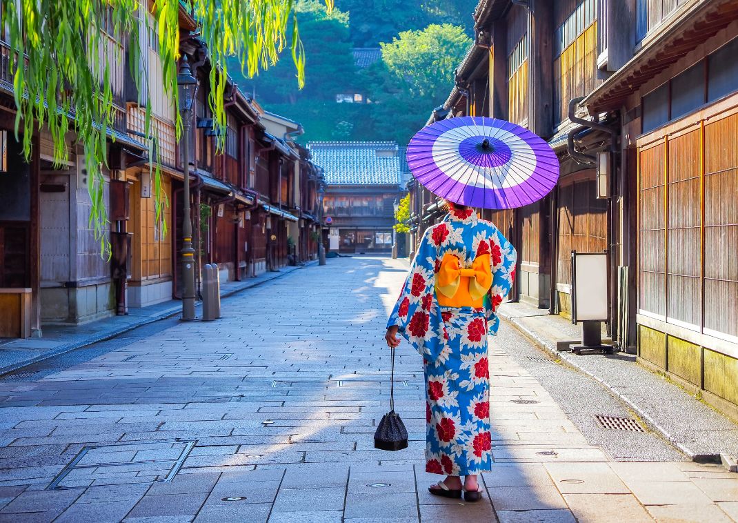 Japanese Geisha walking through traditional Higashi Chaya District in Kanazawa, Japan