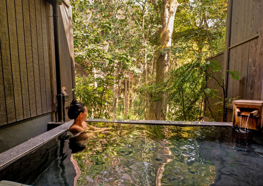 Woman in onsen hot spring, Japan