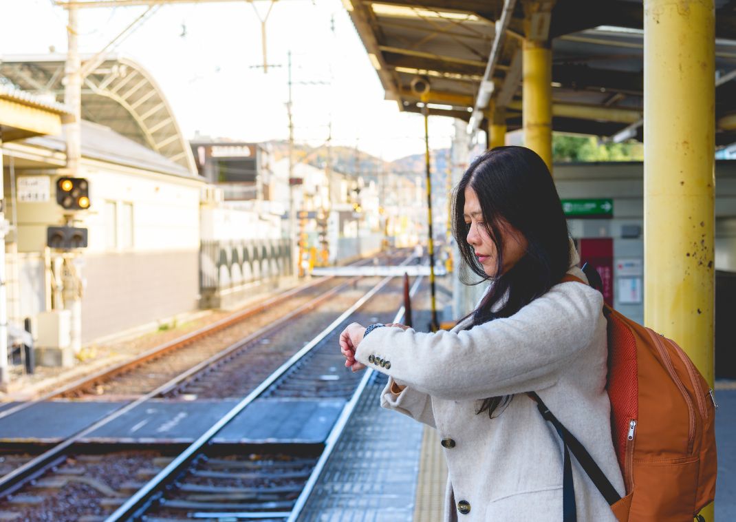 Woman looking at her watch at a train station in Japan