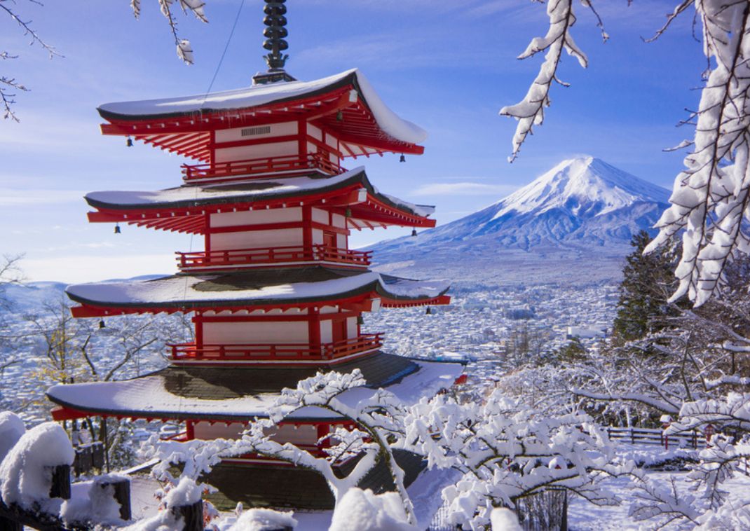 Couple holding hands and walking in wintertime Ouchi-juku village