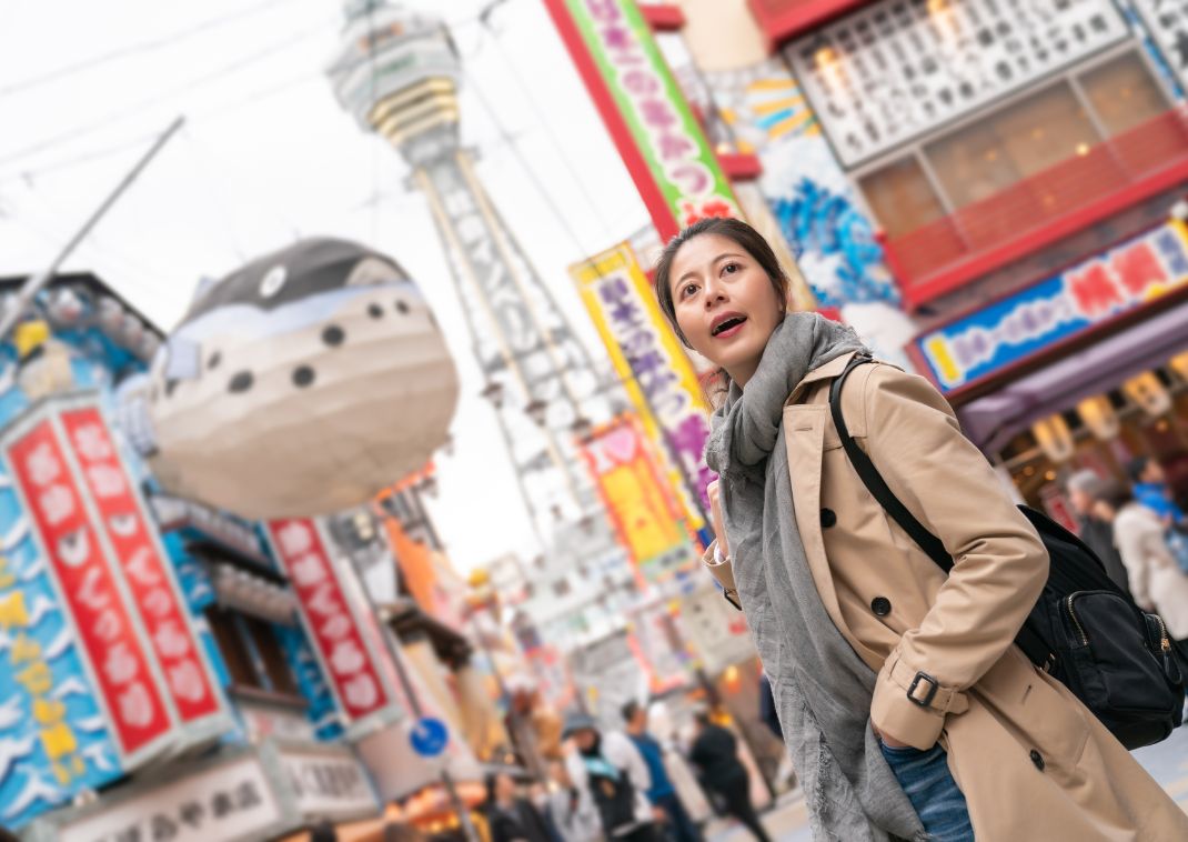 Young Asian woman exploring Osaka’s Shinsekai area