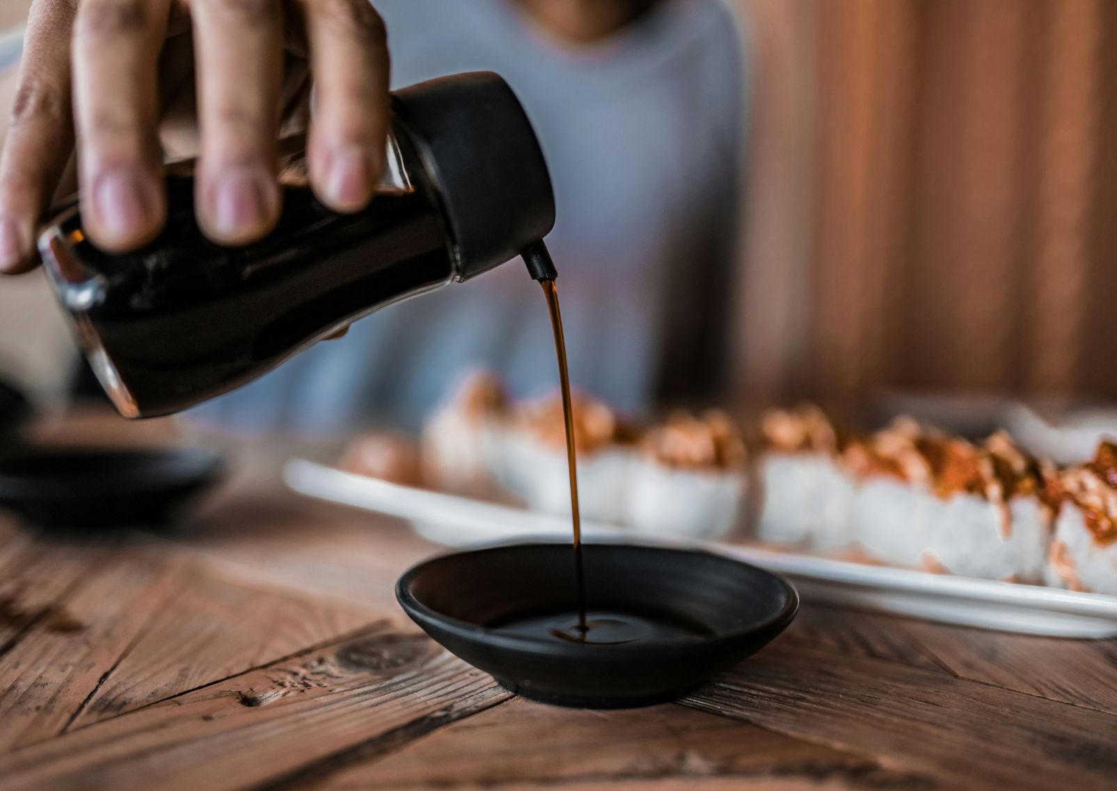 Japanese soy sauce and soy beans on a linen cloth on a table