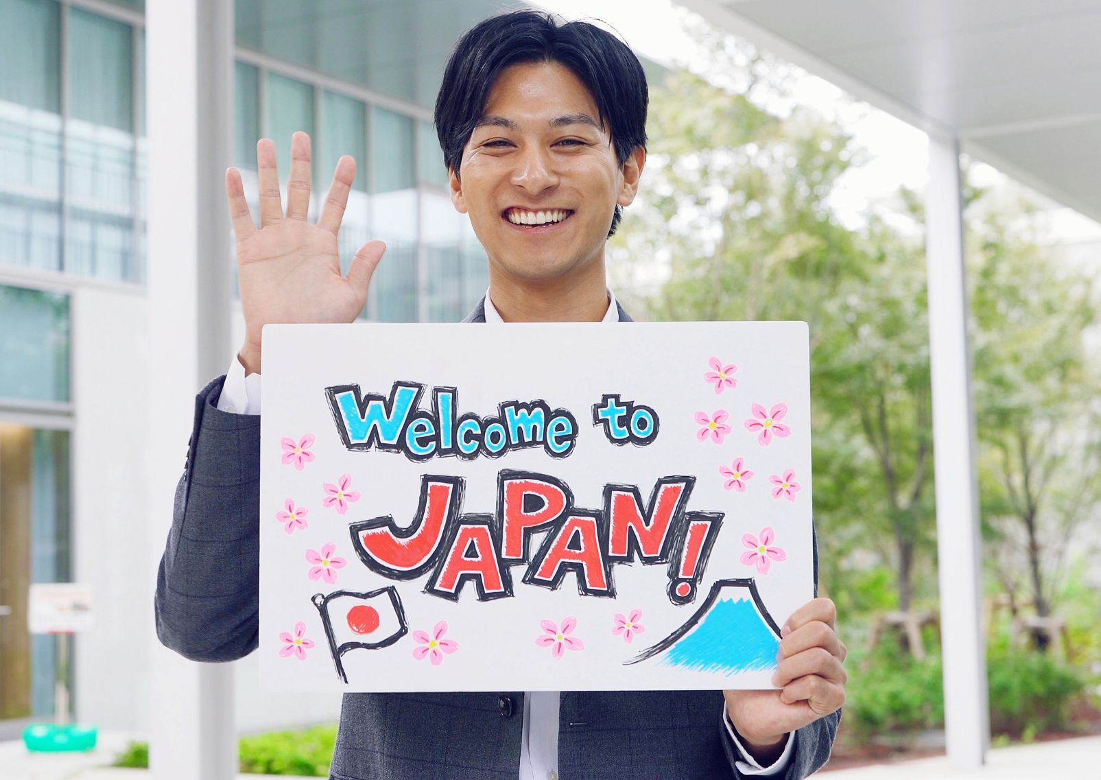 Japanese man holding sign at airport, Japan