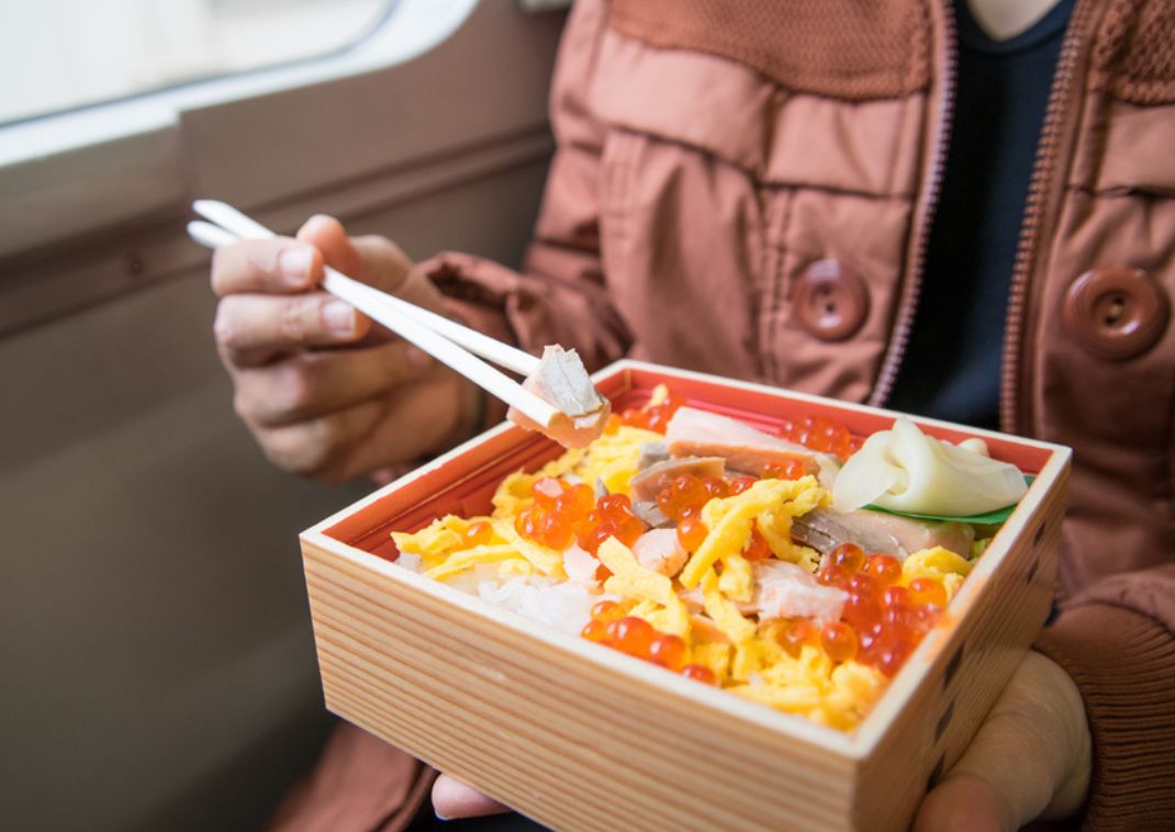 tourist eating japan bento food, wooden