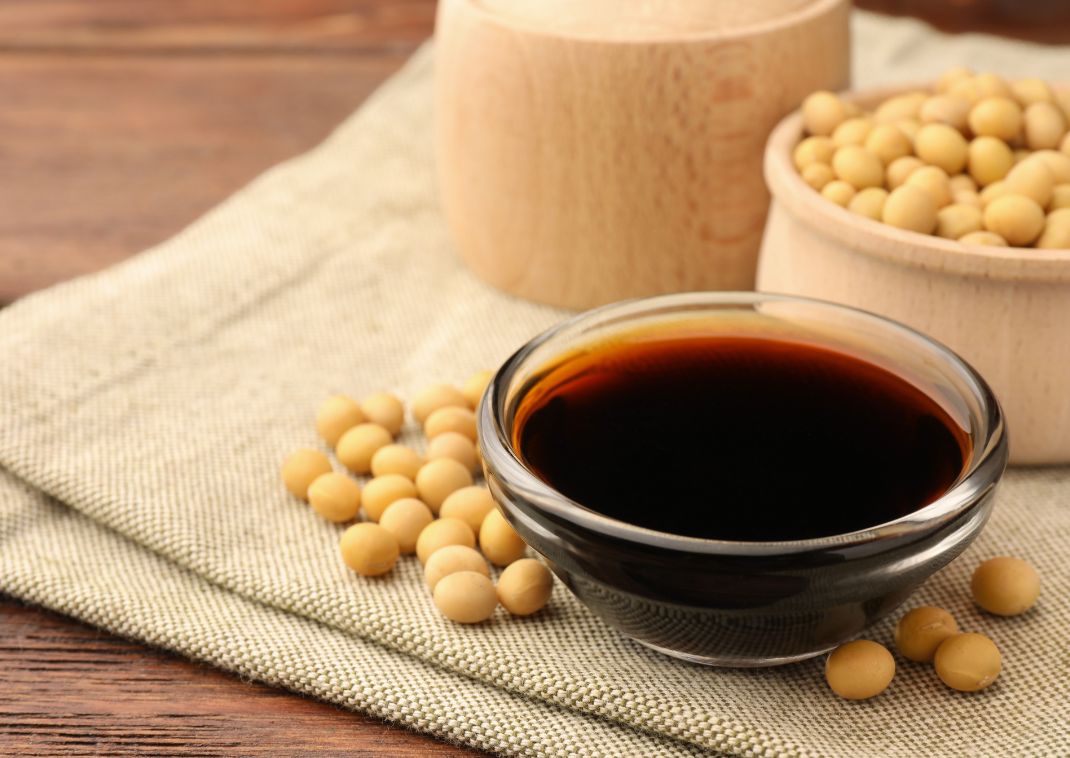 Japanese soy sauce and soy beans on a linen cloth on a table