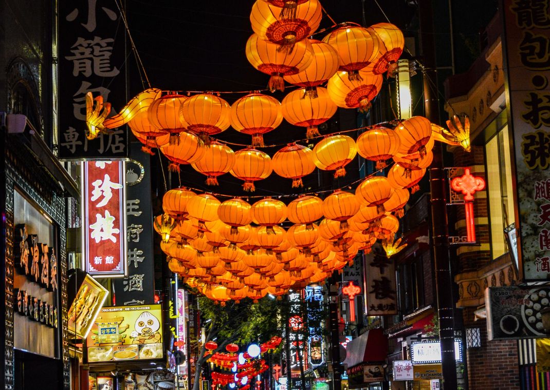 A dragon formed from lanterns hanging above a street in Chinatown