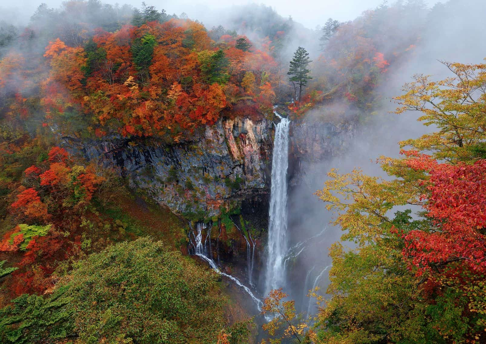 Kegon Falls in autumn surrounded by mist in Nikko, Japan