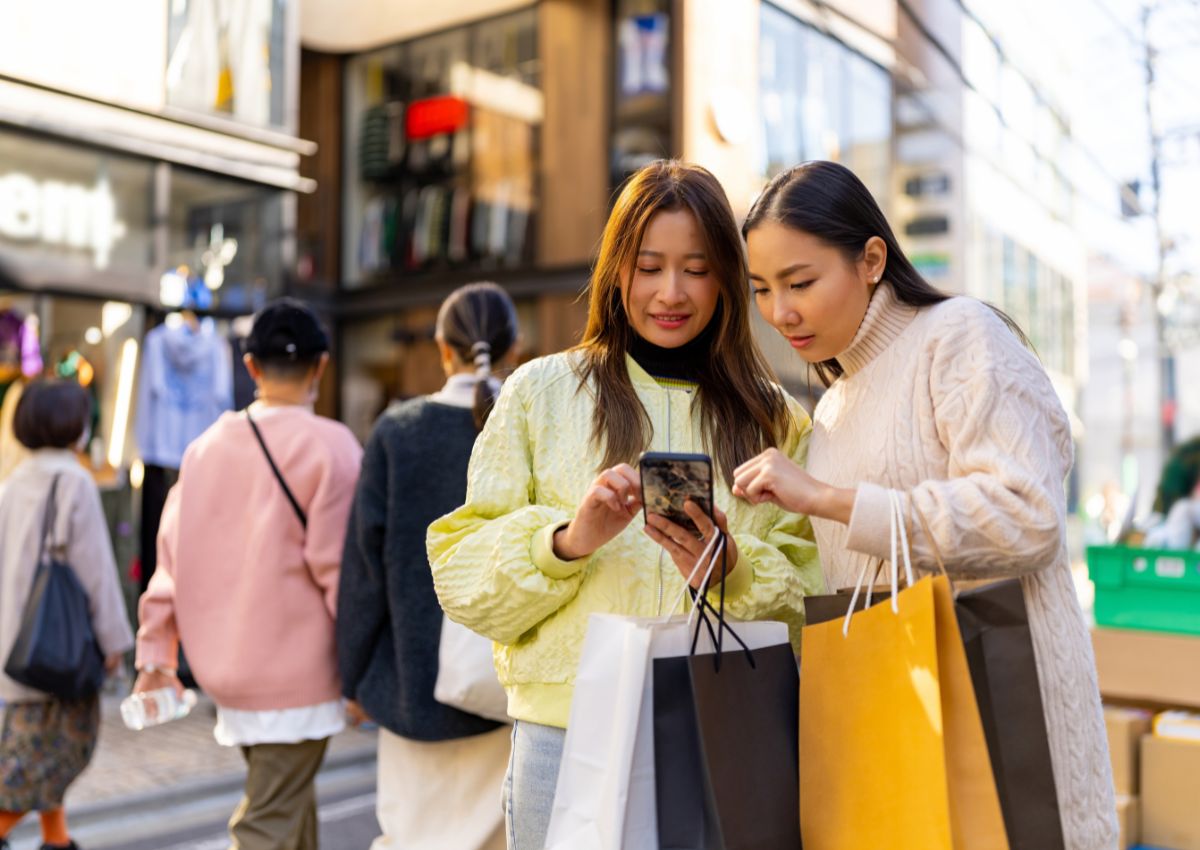 Tourist women in Japan using smartphone while shopping