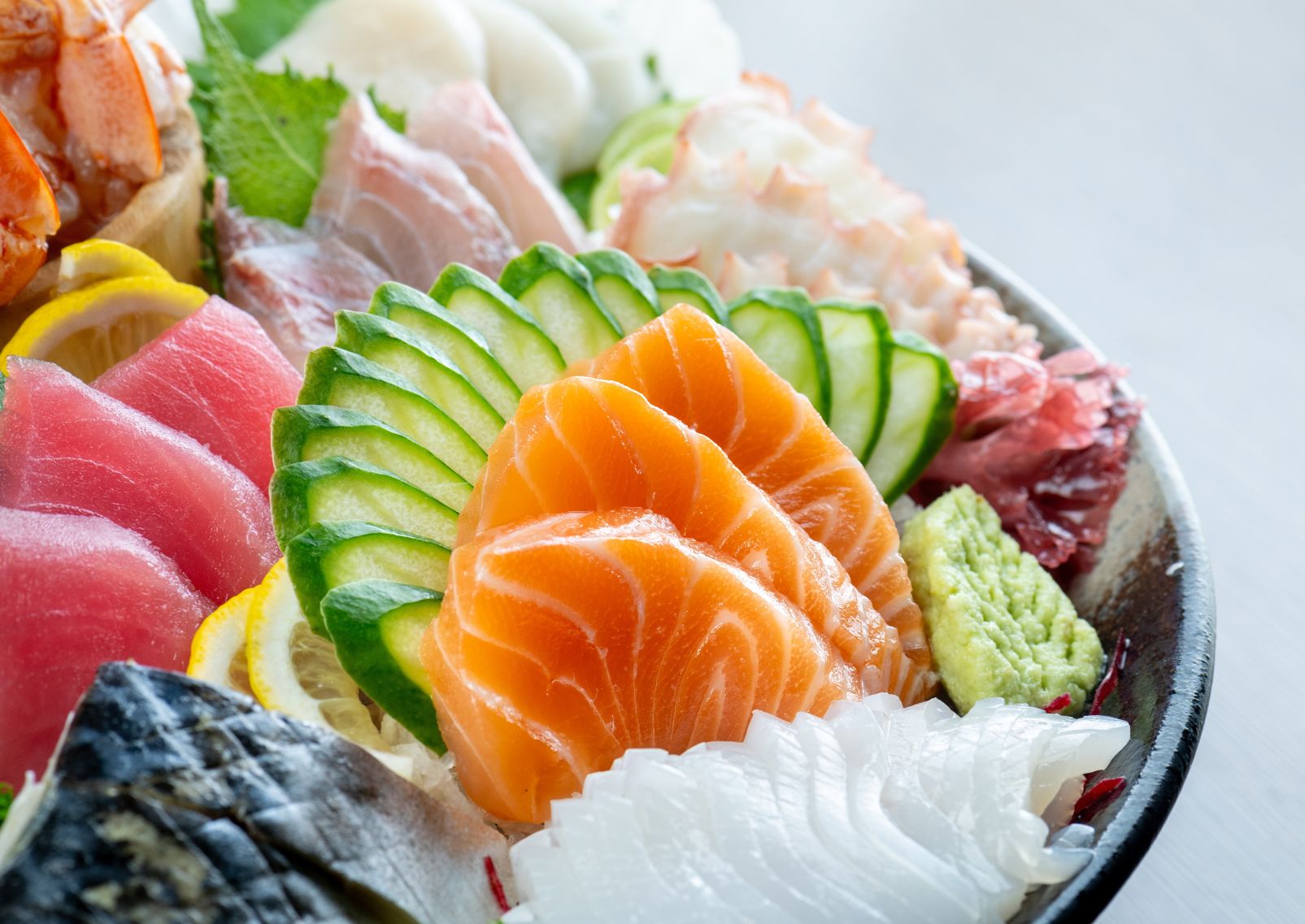 Person eating sushi with chopsticks in a restaurant in traditional Japanese clothing