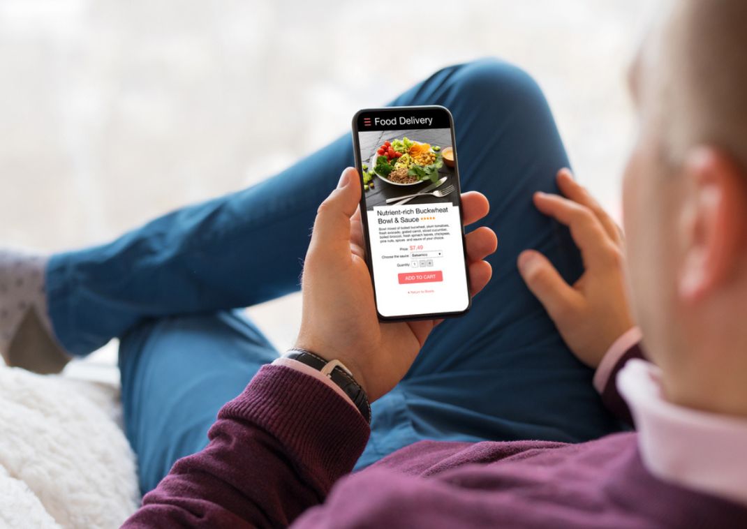 Man looking up healthy meals for delivery on his phone