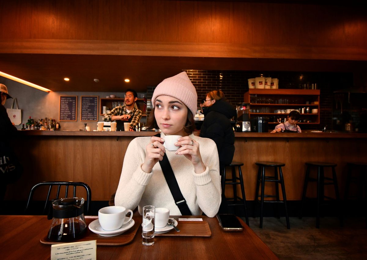 Woman sitting and drinking coffee, coffeeshop Japan