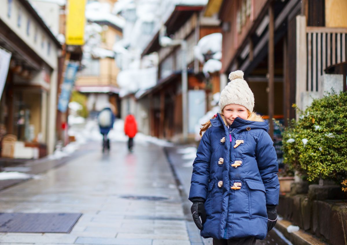 Tourist child at snowy onsen town in Japan