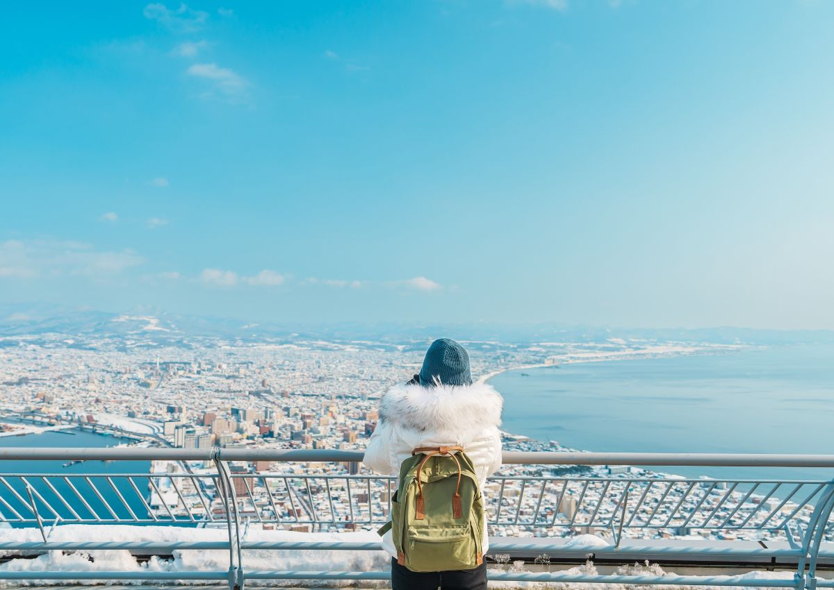 Woman tourist looking down on Hakodate city, Hokkaido, Japan