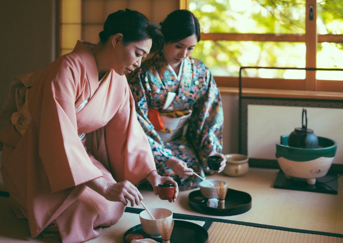 Two women in kimono practicing tea ceremony