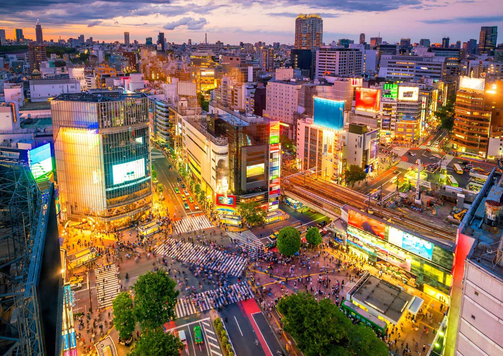 Shibuya Scramble Crossing in the evening with lots of people and buildings