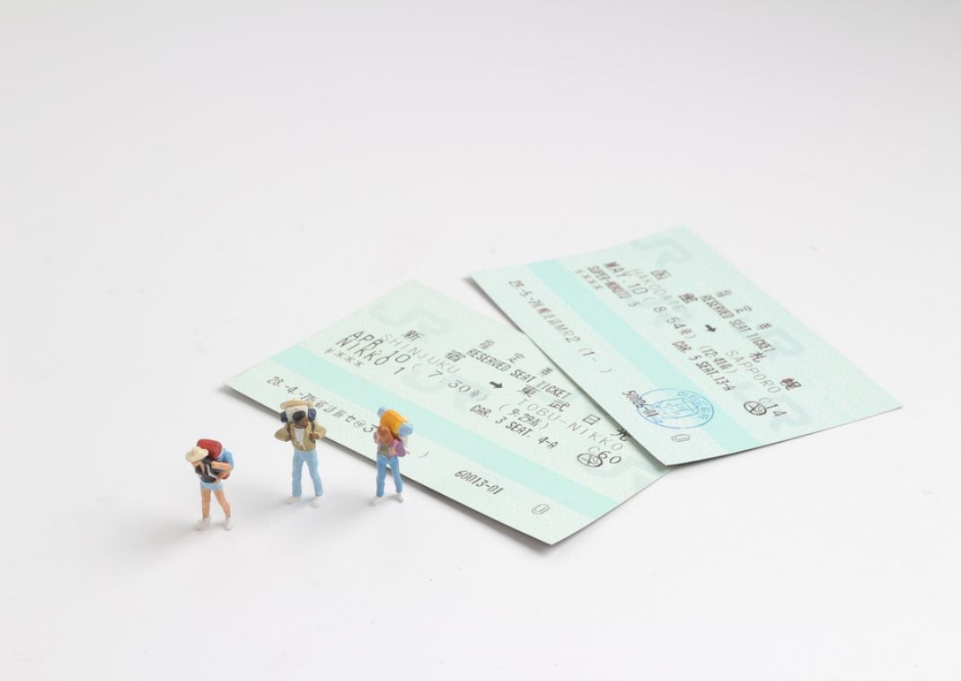 Two Japanese rail tickets on a plain background